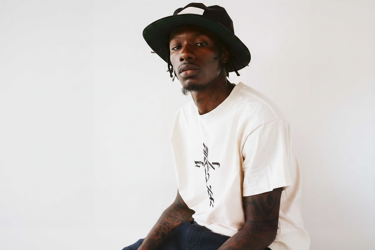 Calligraphy cross logo on front of shirt